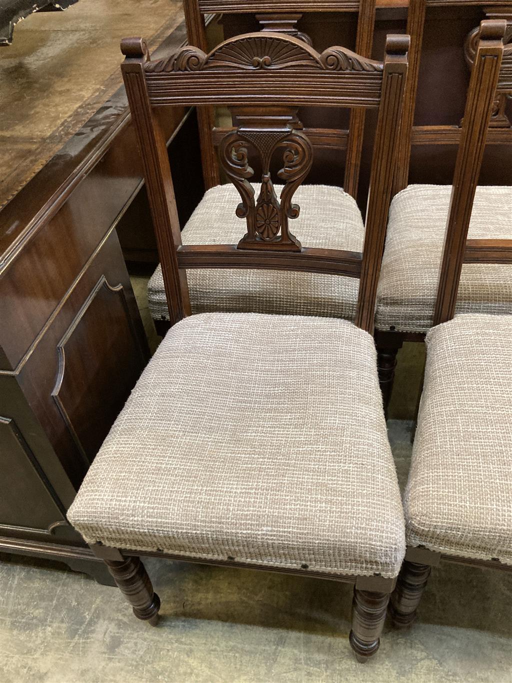 A set of four late Victorian walnut dining chairs